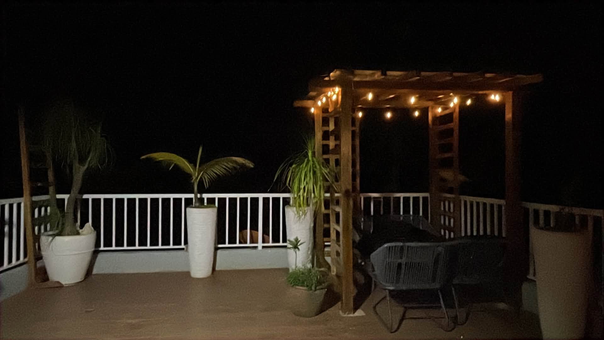 Wide rooftop deck illuminated at night